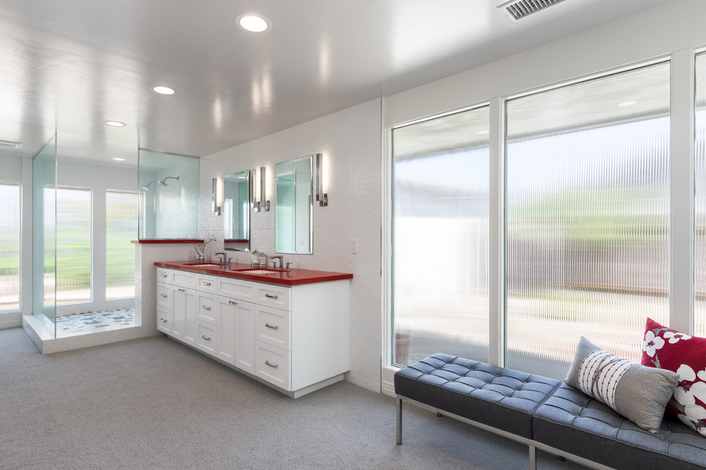 Design ideas for a large midcentury master bathroom in San Diego with recessed-panel cabinets, white cabinets, a corner shower, a two-piece toilet, white tile, ceramic tile, white walls, an undermount sink, granite benchtops, beige floor, an open shower and red benchtops.