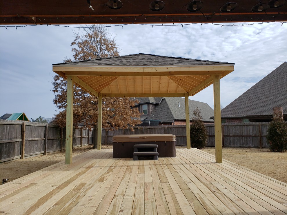 Example of a mid-sized backyard deck design with a pergola