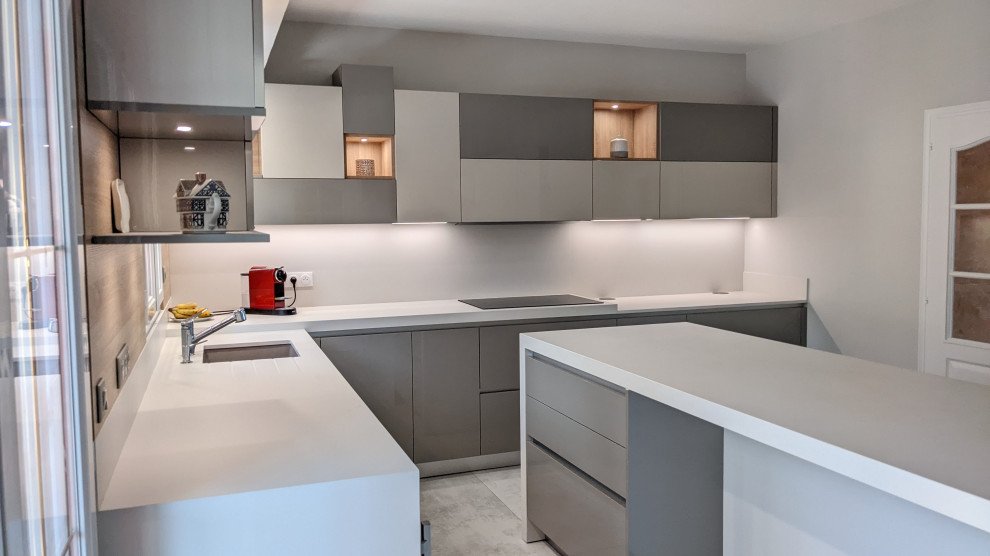 Design ideas for an expansive contemporary galley separate kitchen in Paris with an integrated sink, glass-front cabinets, grey cabinets, quartzite benchtops, white splashback, ceramic splashback, stainless steel appliances and with island.