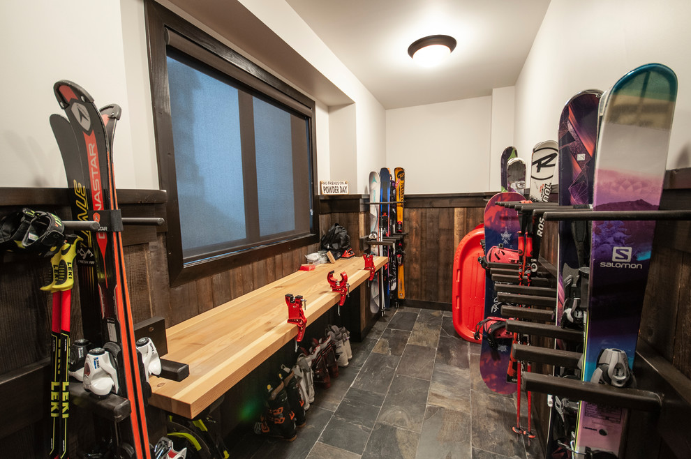 Large mountain style slate floor and multicolored floor mudroom photo in Vancouver with beige walls and a dark wood front door