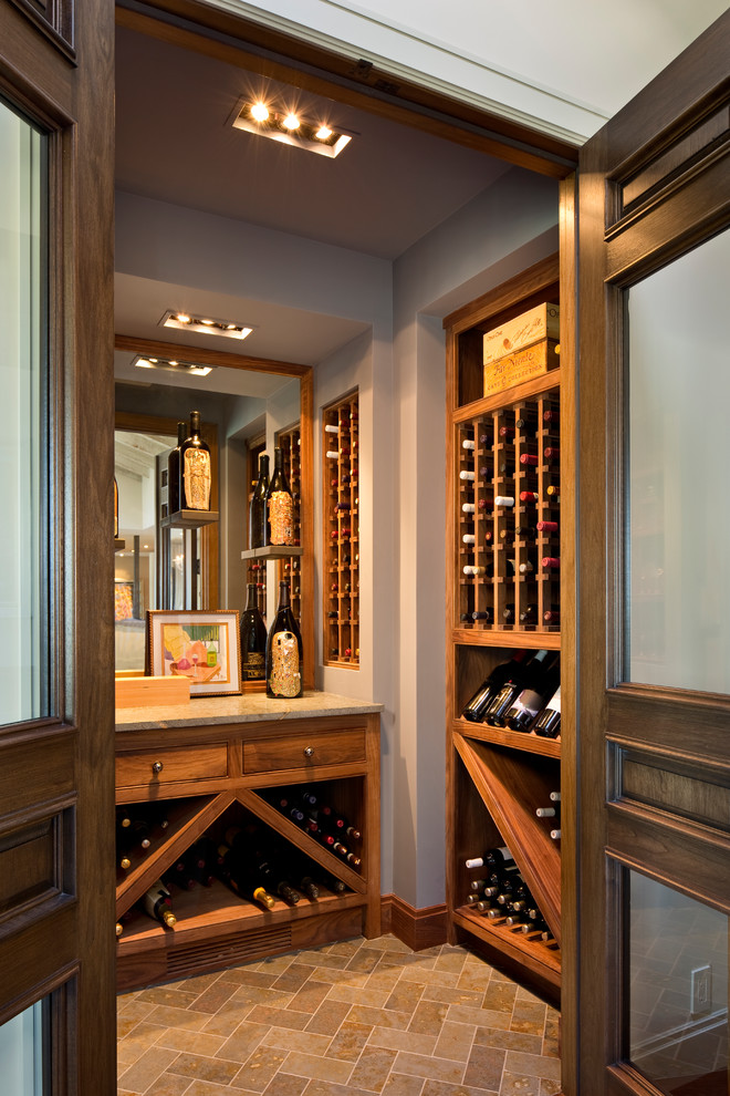 This is an example of a transitional wine cellar in San Francisco with storage racks and brown floor.