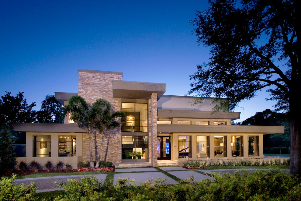 This is an example of a contemporary two-storey stucco beige exterior in Orlando.