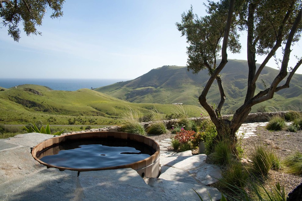 Design ideas for a small country round aboveground pool in Santa Barbara with a hot tub and natural stone pavers.