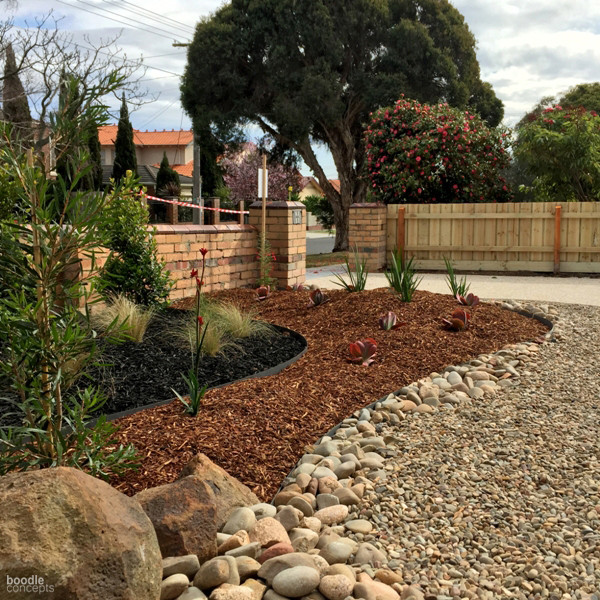 Inspiration for a large modern front yard full sun formal garden for winter in Melbourne with a garden path and mulch.