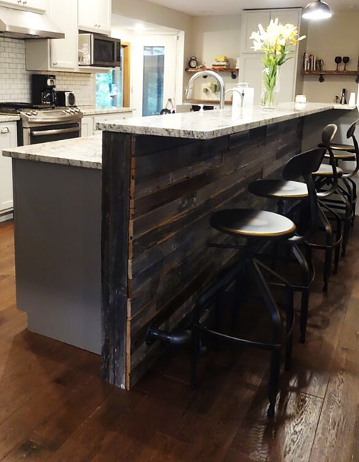 Example of a mid-sized transitional galley dark wood floor eat-in kitchen design with an undermount sink, stainless steel appliances and an island