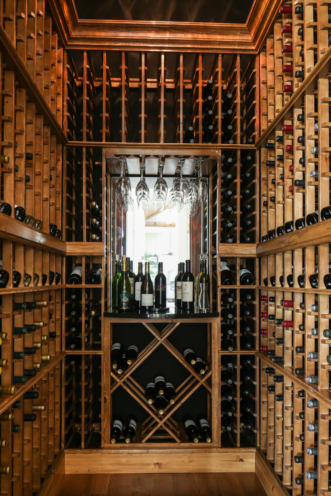 Inspiration for a small traditional wine cellar in New Orleans with medium hardwood floors and storage racks.