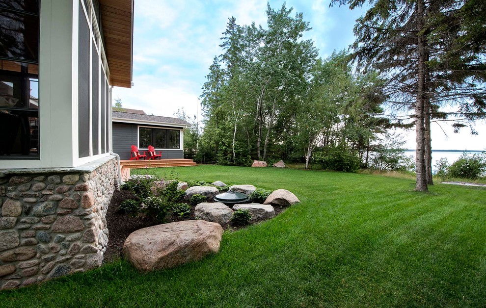 This is an example of a mid-sized rustic partial sun backyard landscaping.