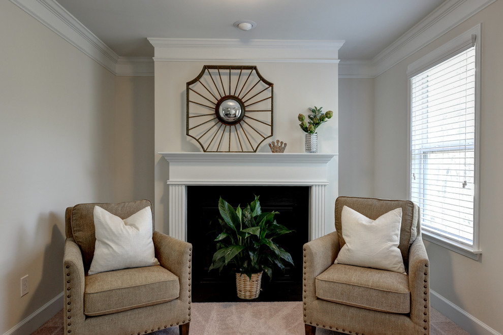 Design ideas for a small transitional formal enclosed living room in Atlanta with beige walls, carpet, a standard fireplace, a plaster fireplace surround and beige floor.
