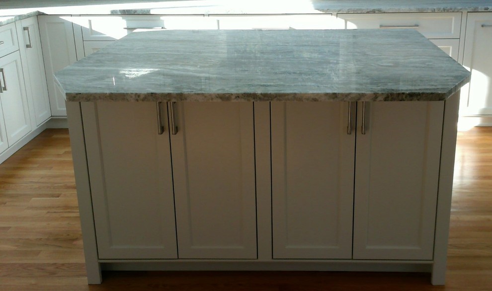Inspiration for a large transitional u-shaped medium tone wood floor enclosed kitchen remodel in Boston with recessed-panel cabinets, white cabinets, granite countertops, gray backsplash, ceramic backsplash and an island