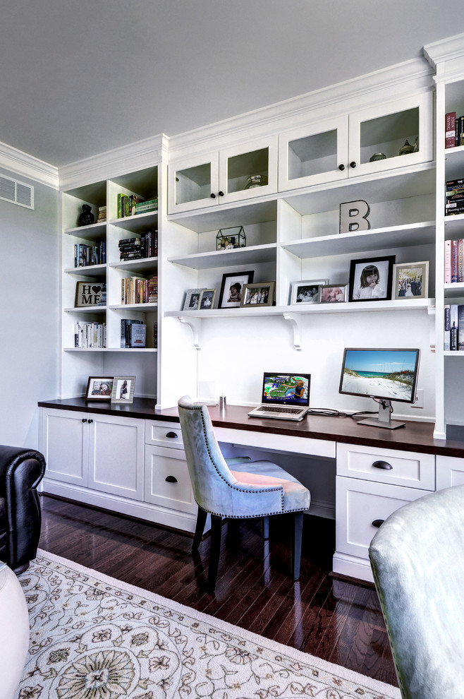 Mid-sized transitional built-in desk medium tone wood floor study room photo in Philadelphia with gray walls