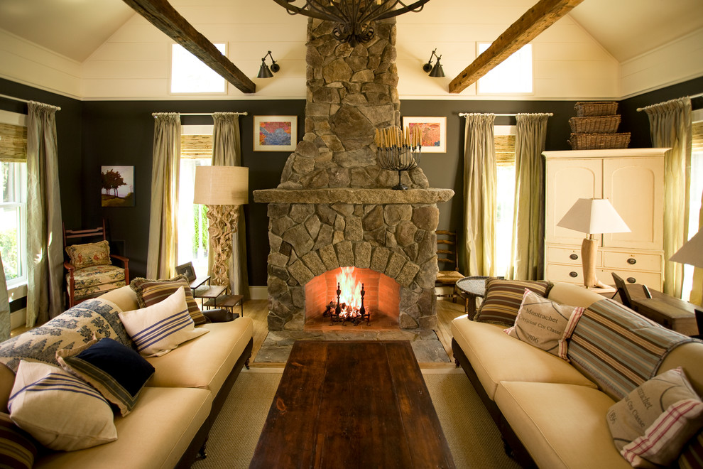 This is an example of a country enclosed living room in Portland Maine with brown walls and a stone fireplace surround.