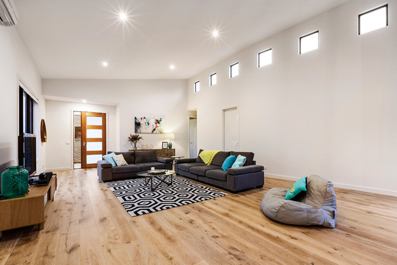 This is an example of a contemporary family room in Melbourne.