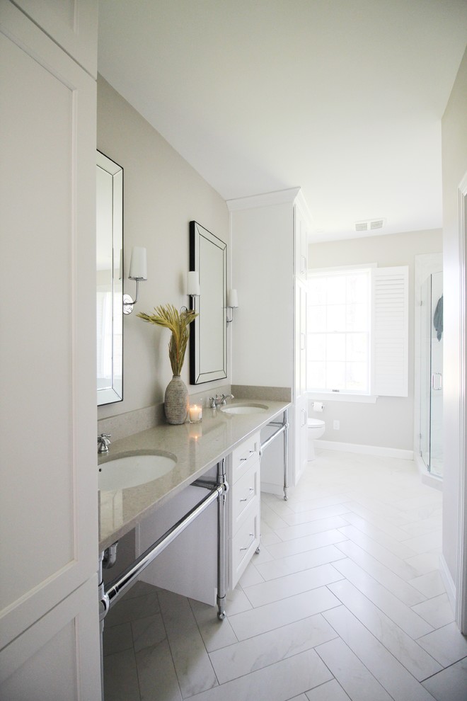 Design ideas for a mid-sized transitional master bathroom in Other with shaker cabinets, white cabinets, an alcove shower, a one-piece toilet, white tile, ceramic tile, beige walls, porcelain floors, an undermount sink, quartzite benchtops, yellow floor and a hinged shower door.