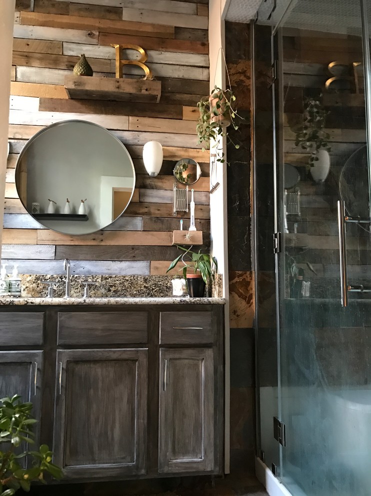 Mid-sized country master bathroom in New Orleans with recessed-panel cabinets, distressed cabinets, a one-piece toilet, multi-coloured tile, mirror tile, grey walls, slate floors, an undermount sink, granite benchtops, multi-coloured floor and a hinged shower door.
