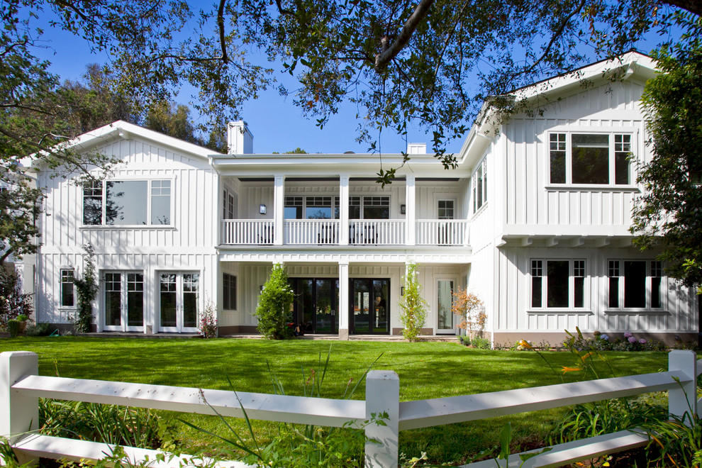 Design ideas for a traditional two-storey white exterior in Los Angeles with wood siding.
