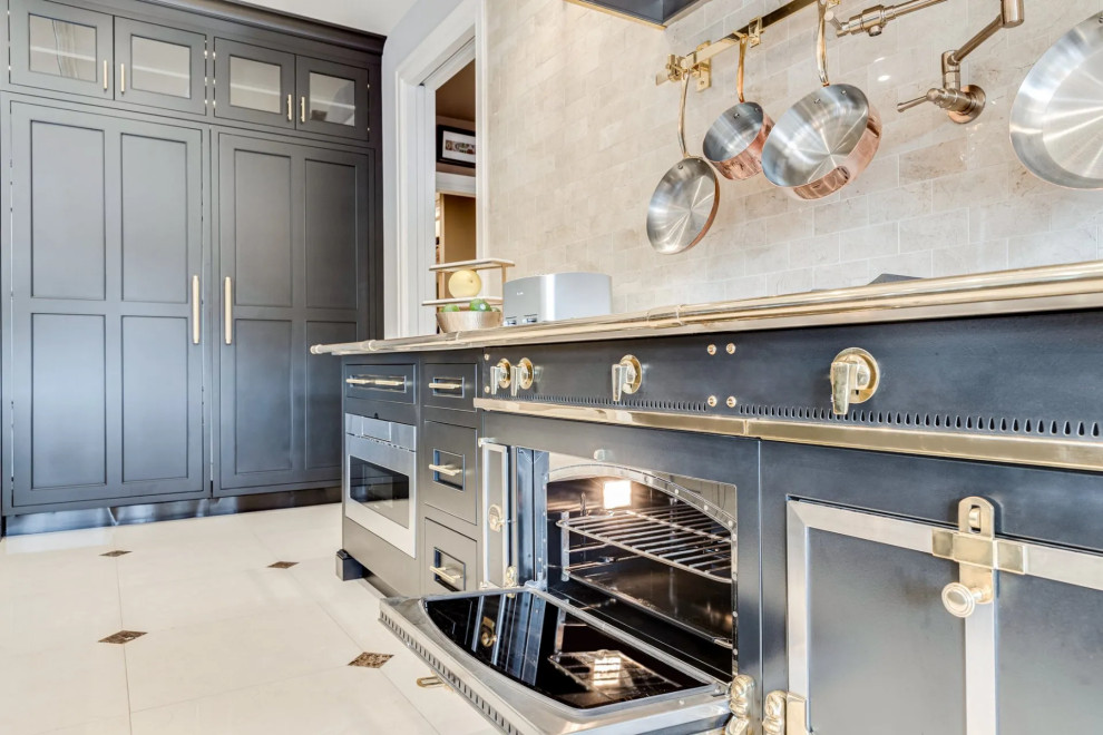 Kitchen - transitional beige floor kitchen idea in Baltimore with black cabinets, beige backsplash, an island and beige countertops