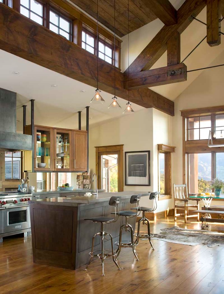 Inspiration for a country open plan kitchen in Denver with glass-front cabinets, medium wood cabinets and stainless steel appliances.