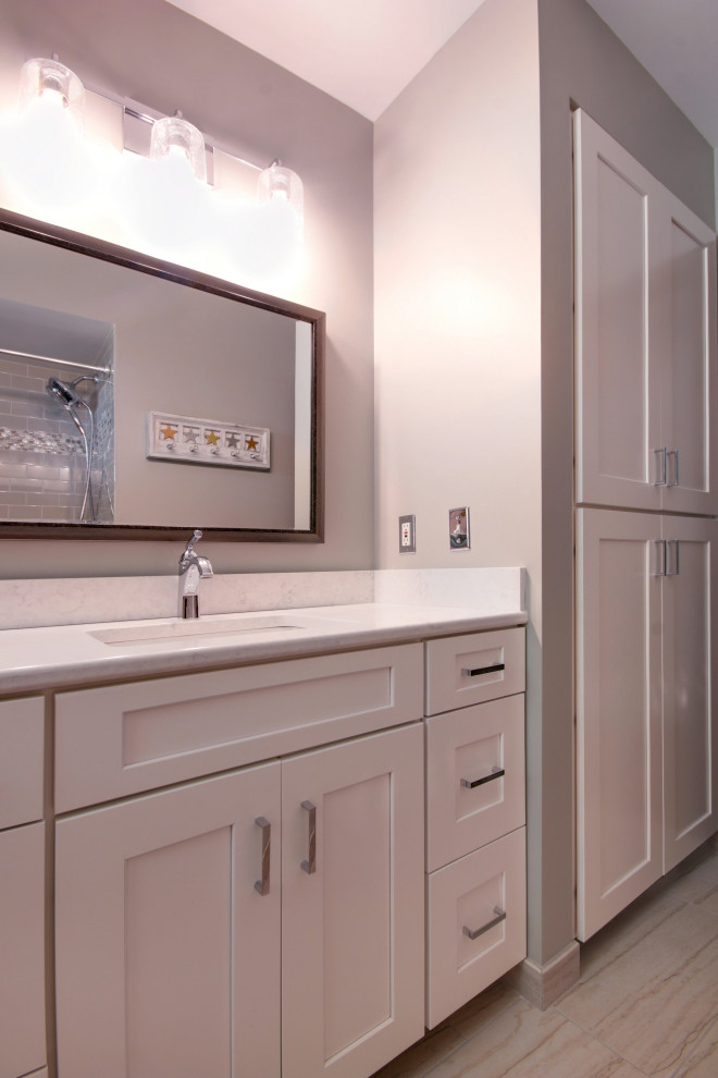Inspiration for a small traditional master bathroom in Grand Rapids with recessed-panel cabinets, white cabinets, a shower/bathtub combo, grey walls, ceramic floors, an undermount sink, engineered quartz benchtops, multi-coloured floor and multi-coloured benchtops.