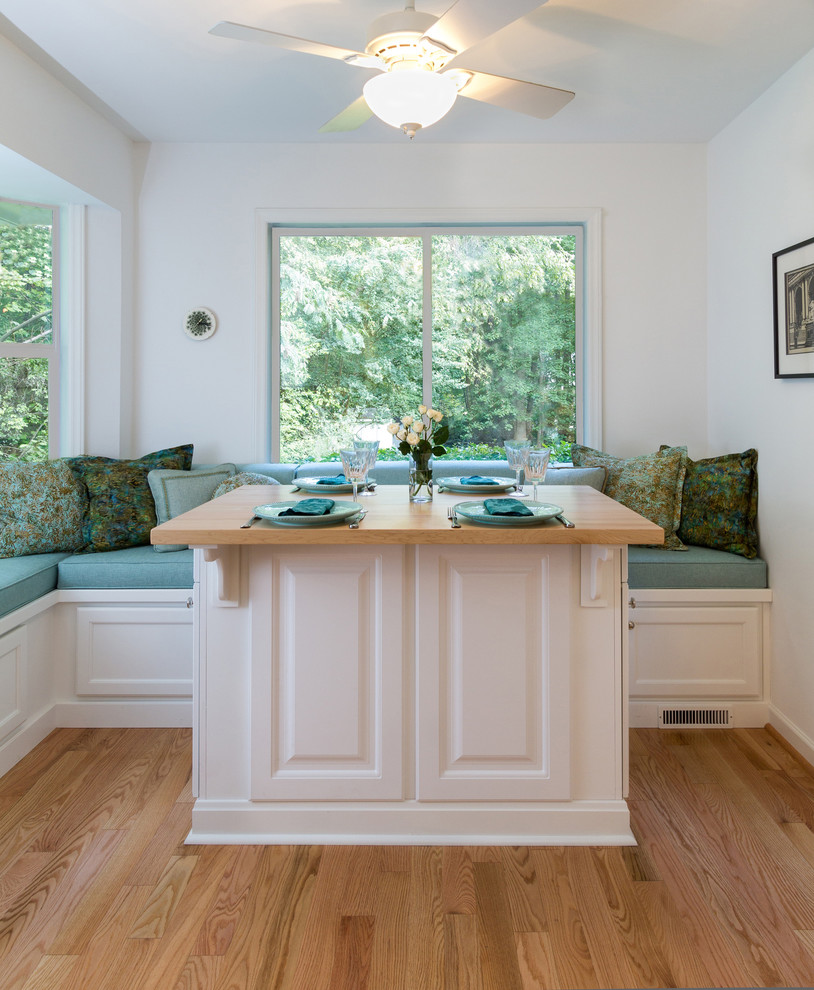 Enclosed dining room - transitional galley enclosed dining room idea in Raleigh with an undermount sink, raised-panel cabinets, white cabinets, wood countertops, gray backsplash, porcelain backsplash and white appliances