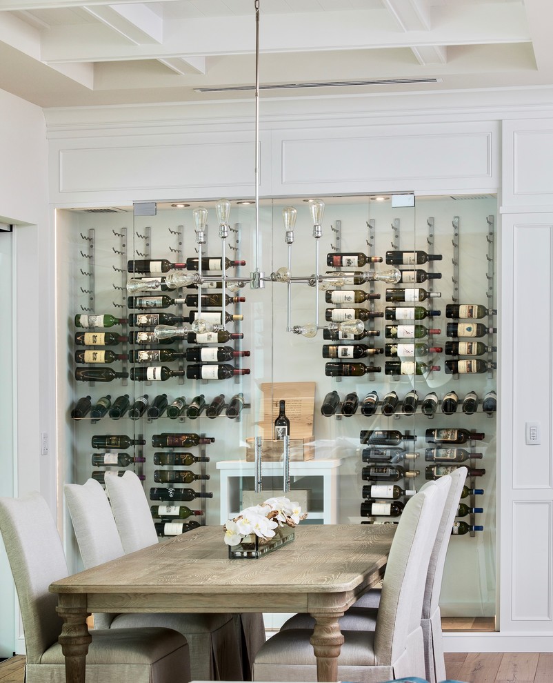 Photo of a mid-sized contemporary wine cellar in Miami with cork floors, storage racks and beige floor.