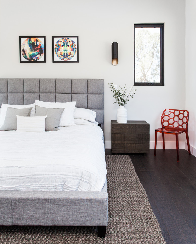 Example of a trendy dark wood floor bedroom design in Sacramento with white walls