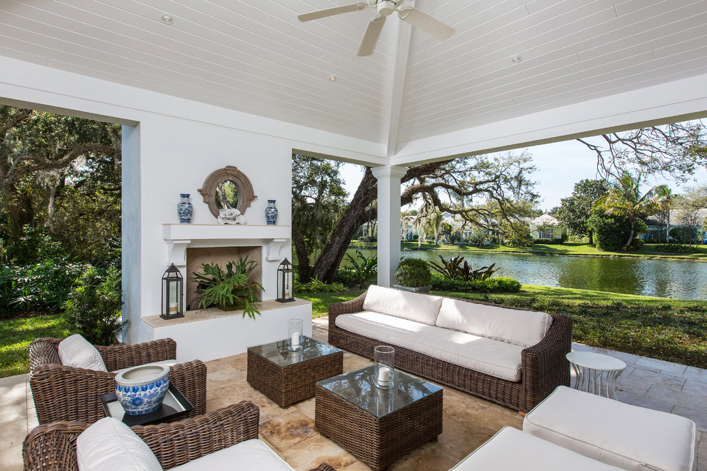 Inspiration for a traditional backyard patio in Miami with a roof extension.