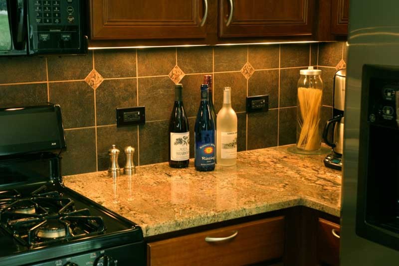 Inspiration for a transitional u-shaped medium tone wood floor kitchen pantry remodel in Chicago with raised-panel cabinets, medium tone wood cabinets and granite countertops