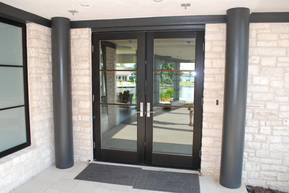 Design ideas for a large contemporary front door in Austin with a double front door and a black front door.