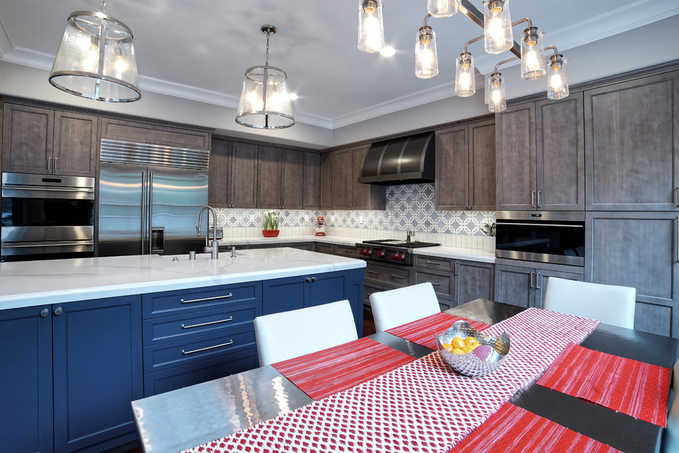 Large transitional l-shaped medium tone wood floor and red floor open concept kitchen photo in San Francisco with a farmhouse sink, recessed-panel cabinets, light wood cabinets, quartz countertops, multicolored backsplash, marble backsplash, stainless steel appliances, an island and white countertops