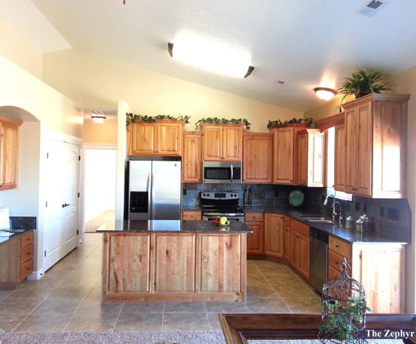 Large country eat-in kitchen in Las Vegas with a double-bowl sink, raised-panel cabinets, granite benchtops, ceramic splashback, stainless steel appliances, ceramic floors and with island.