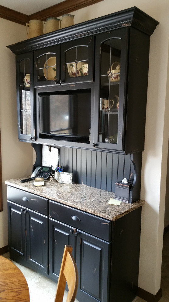 Photo of a mid-sized traditional galley eat-in kitchen in Chicago with raised-panel cabinets, black cabinets, quartz benchtops, black splashback, timber splashback and beige benchtop.