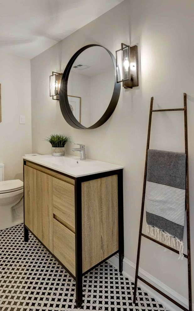 Design ideas for a large modern powder room in New York with medium hardwood floors, flat-panel cabinets, light wood cabinets, grey walls, an integrated sink, engineered quartz benchtops, white benchtops and a freestanding vanity.