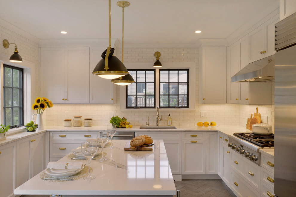 Small transitional u-shaped porcelain tile and gray floor enclosed kitchen photo in New York with an undermount sink, recessed-panel cabinets, gray cabinets, quartz countertops, white backsplash, ceramic backsplash, stainless steel appliances, an island and white countertops