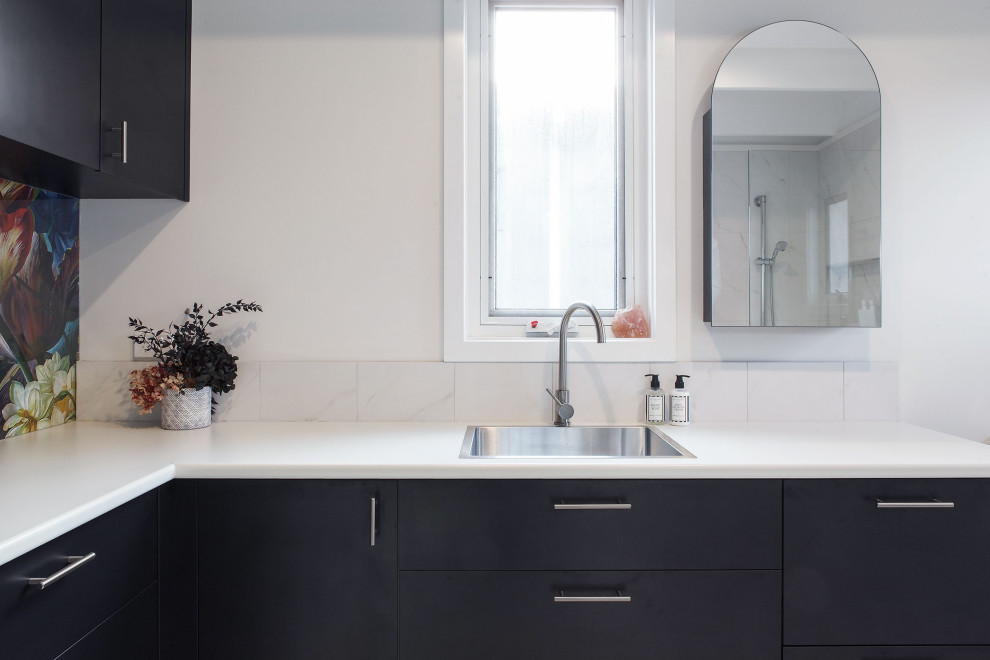 Mid-sized modern bathroom in Melbourne with blue cabinets, white tile and a single vanity.