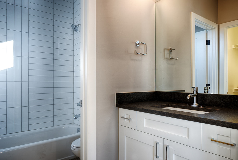Arts and crafts 3/4 alcove bathtub photo in Denver with shaker cabinets, white cabinets, beige walls and an undermount sink