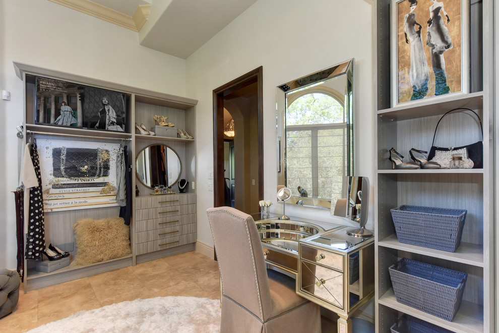 Design ideas for an expansive transitional women's dressing room in Sacramento with open cabinets, grey cabinets, limestone floors and beige floor.