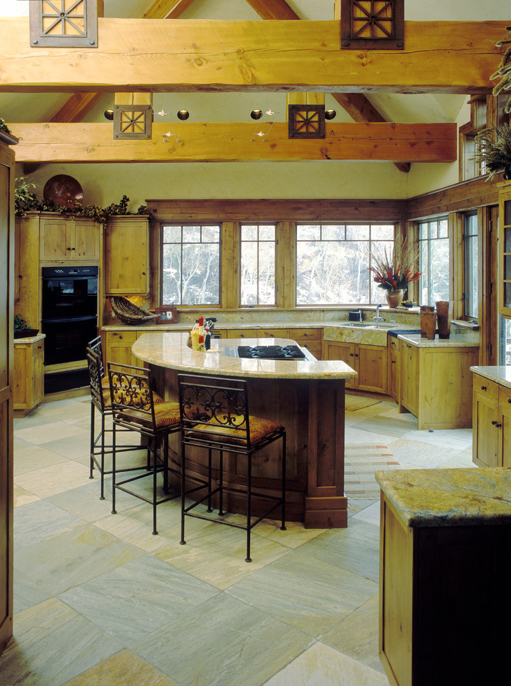 Mid-sized mountain style u-shaped multicolored floor enclosed kitchen photo in Denver with a farmhouse sink, shaker cabinets, light wood cabinets, granite countertops, black appliances, an island and multicolored countertops