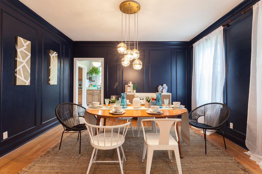 Design ideas for a mid-sized transitional separate dining room in Nashville with blue walls and medium hardwood floors.