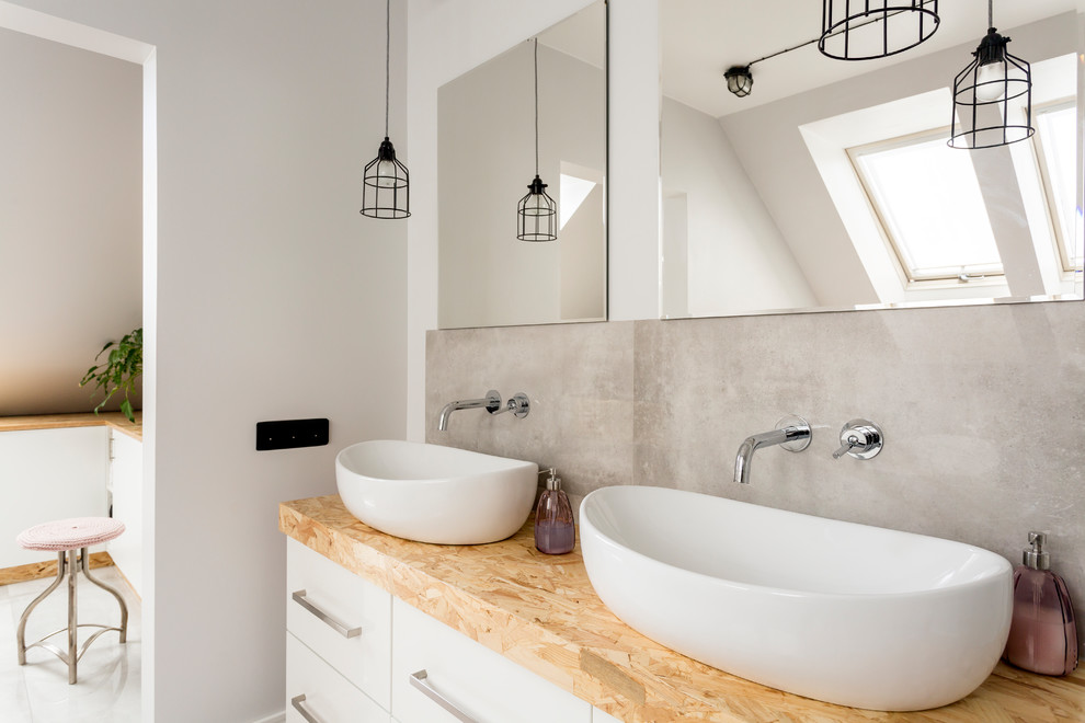 Inspiration for a large contemporary master bathroom in Los Angeles with flat-panel cabinets, white cabinets, a freestanding tub, an open shower, a one-piece toilet, white tile, cement tile, white walls, marble floors, a vessel sink, wood benchtops, grey floor and an open shower.