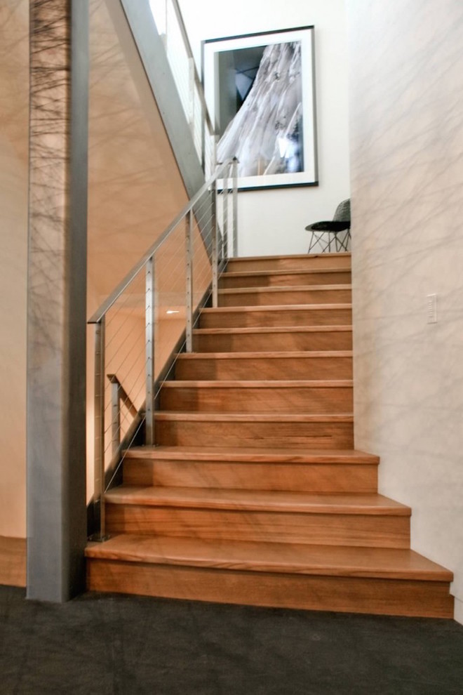This is an example of a mid-sized contemporary wood straight staircase in Sacramento with wood risers and cable railing.