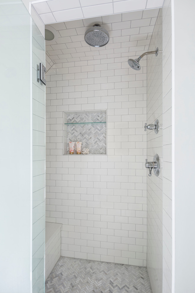 This is an example of a large traditional master bathroom in Minneapolis with recessed-panel cabinets, white cabinets, a claw-foot tub, marble floors, engineered quartz benchtops, a shower/bathtub combo, white tile, stone tile, grey walls and a console sink.