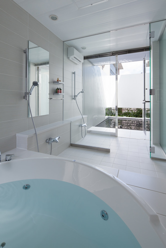 Photo of a contemporary bathroom in Osaka with a hot tub, a double shower, white tile and white walls.