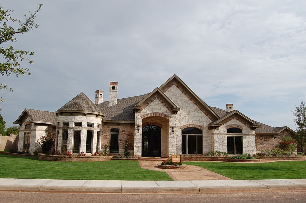 Design ideas for a large traditional one-storey white exterior in Austin with stone veneer.