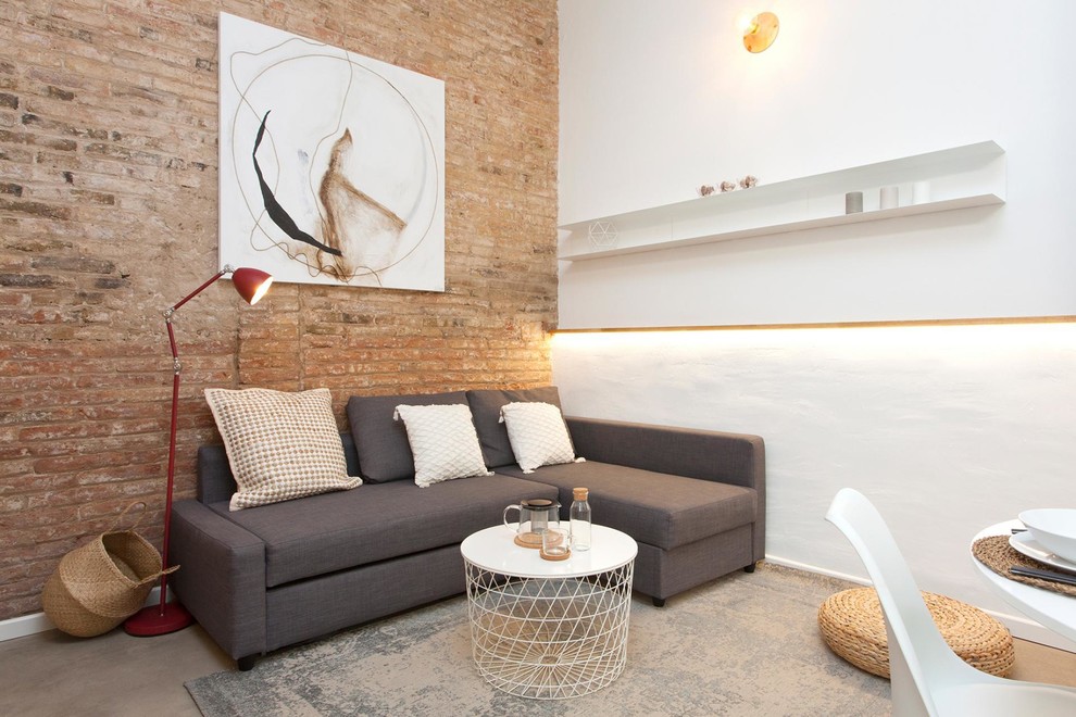Photo of a small mediterranean living room in Barcelona with white walls and grey floor.