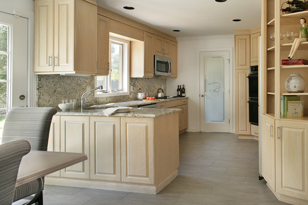 Mid-sized eclectic l-shaped porcelain tile enclosed kitchen photo in Newark with an undermount sink, raised-panel cabinets, light wood cabinets, granite countertops, gray backsplash, stone slab backsplash, stainless steel appliances and a peninsula