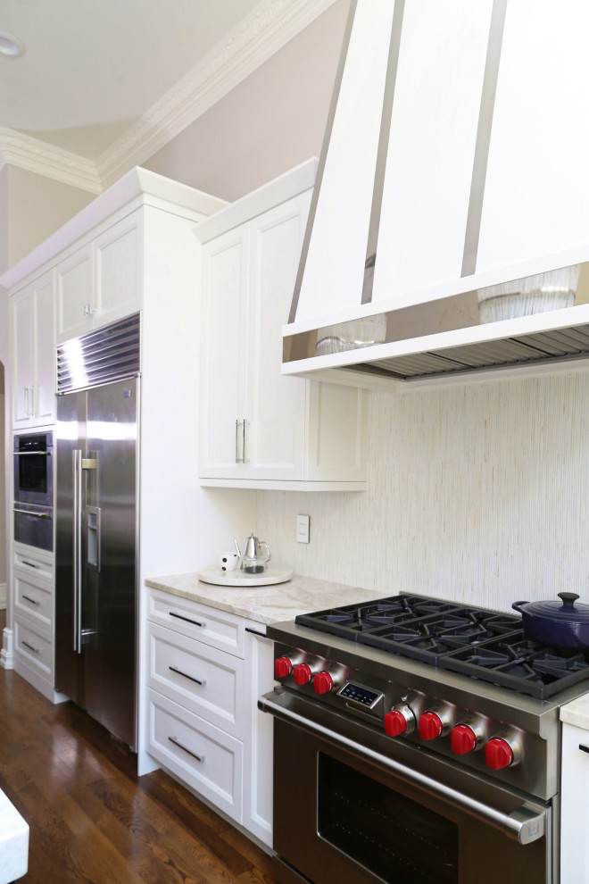 Example of a huge transitional medium tone wood floor and brown floor eat-in kitchen design with an undermount sink, recessed-panel cabinets, white cabinets, quartzite countertops, white backsplash, ceramic backsplash, stainless steel appliances, an island and white countertops