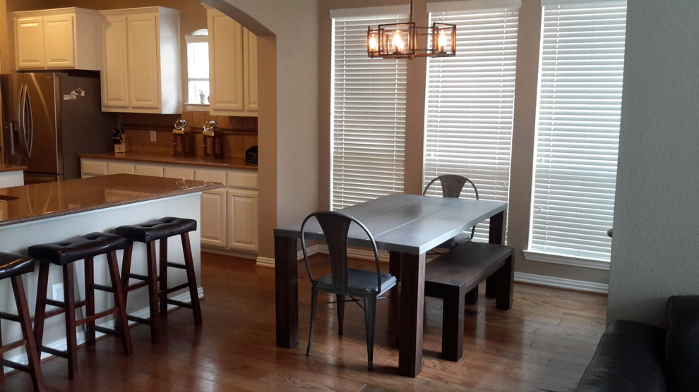 Mid-sized industrial dining room in Dallas with beige walls and dark hardwood floors.