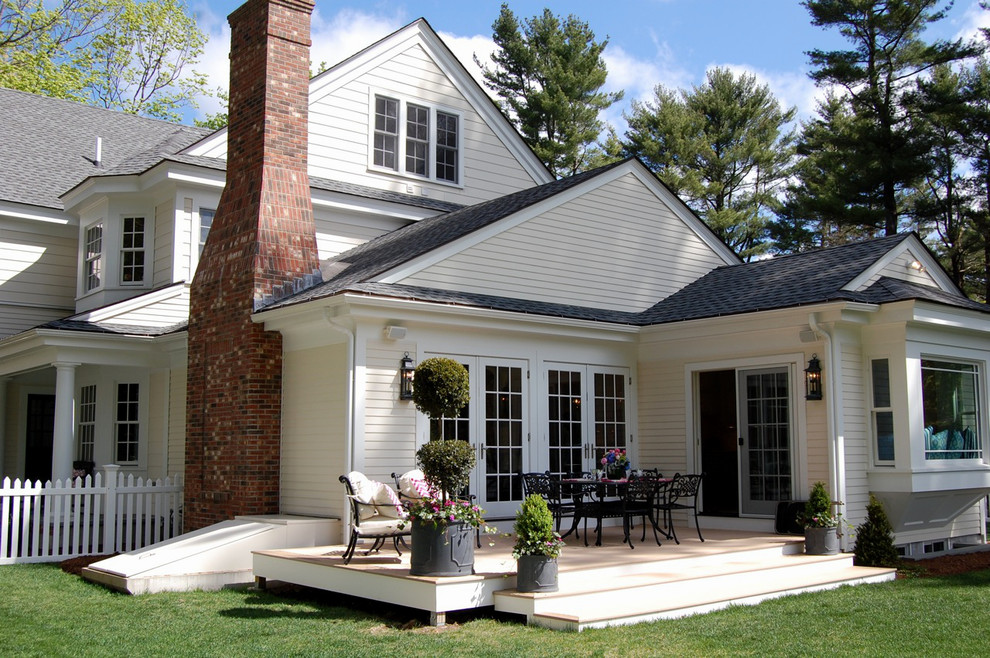 This is an example of a mid-sized traditional backyard deck in Boston with no cover.