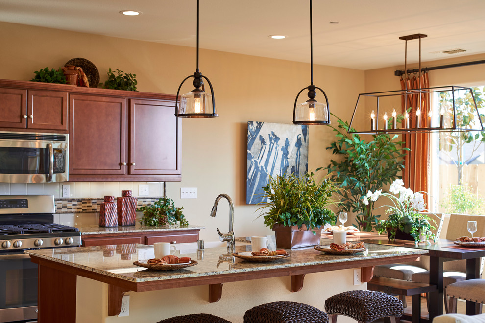 Transitional kitchen photo with a farmhouse sink, granite countertops, beige backsplash, ceramic backsplash, stainless steel appliances and an island
