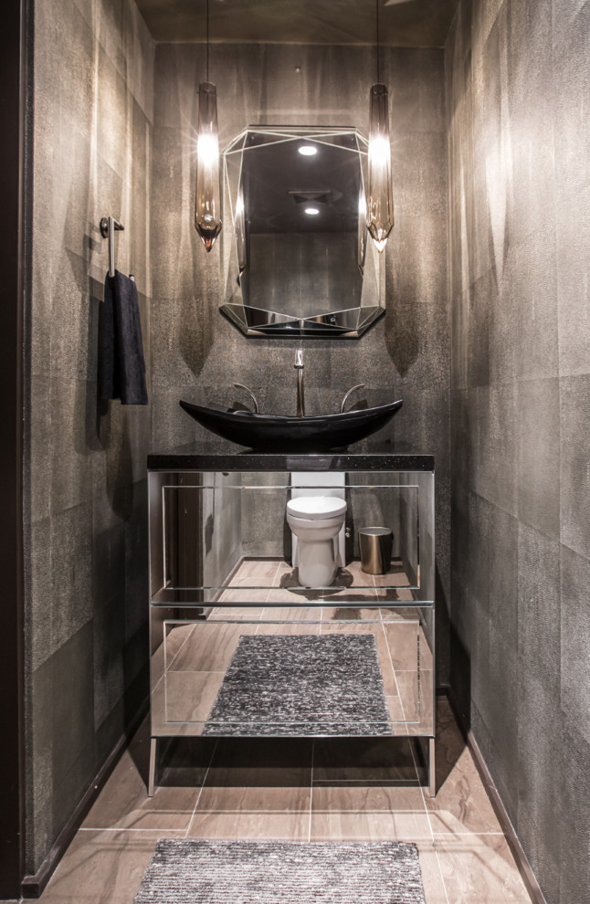 Small contemporary powder room in Phoenix with ceramic floors, engineered quartz benchtops, beige floor, furniture-like cabinets, grey walls, a vessel sink and black benchtops.